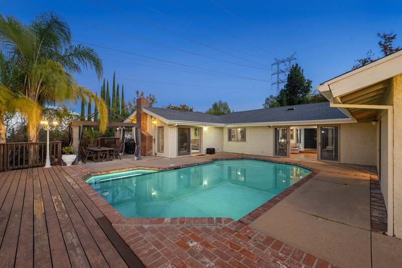 Casa con alberca y jardín al atardecer en Lomas de Angelópolis, una de las Mejores zonas para invertir en bienes raíces en Puebla en el 2026, con entorno residencial exclusivo y alta plusvalía.